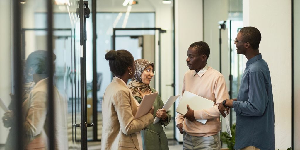 coworkers chatting after meeting for social impact